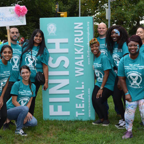 teal walk ovarian cancer run 5k finish line group smile happy awareness